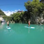 Go paddleboarding on emerald water of Soča